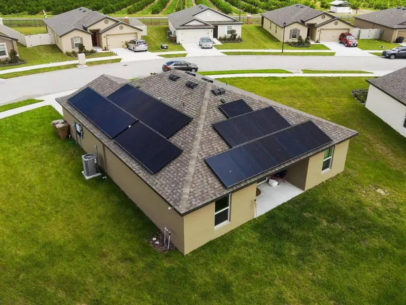 Aerial view of a single-story home with solar panels on its roof