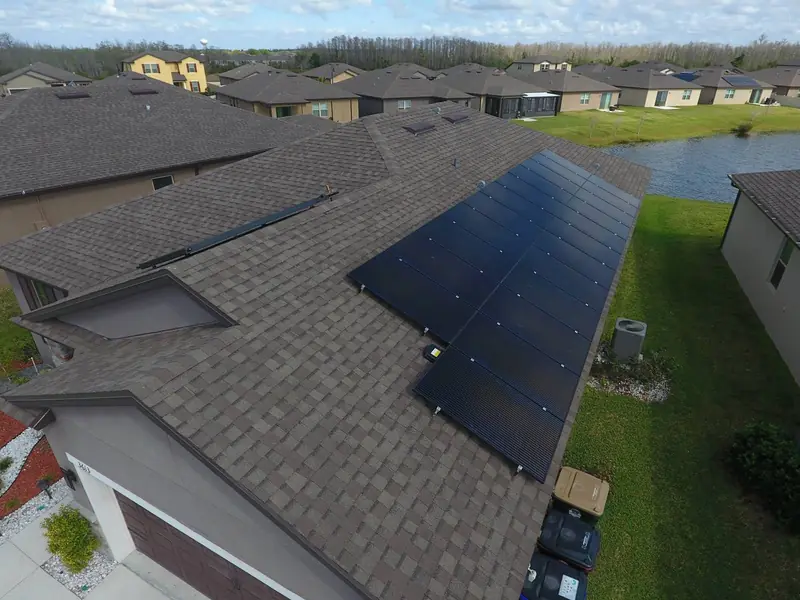 Rooftop solar array on a home beside a lake