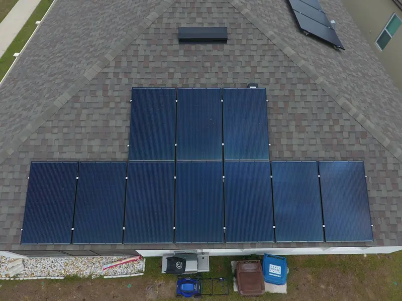 Solar panels arranged in a T shape on a shingle roof